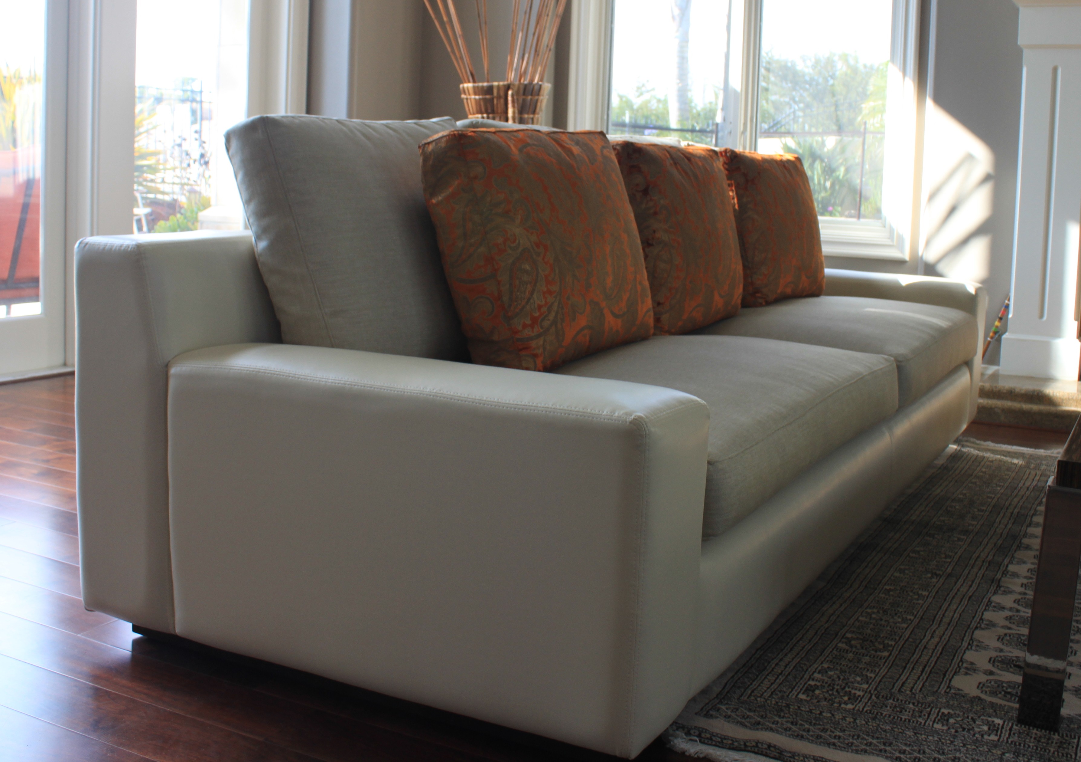 Custom sofa in vinyl body and linen cushions